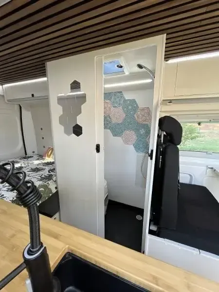Baño cerrado de una furgoneta camper con WC químico de cassette